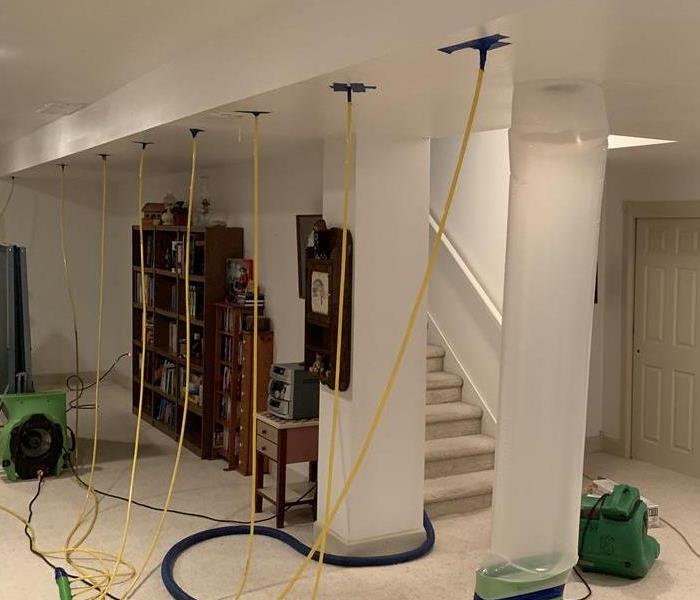 Family Room with equipment setup to put air through the ceiling 
