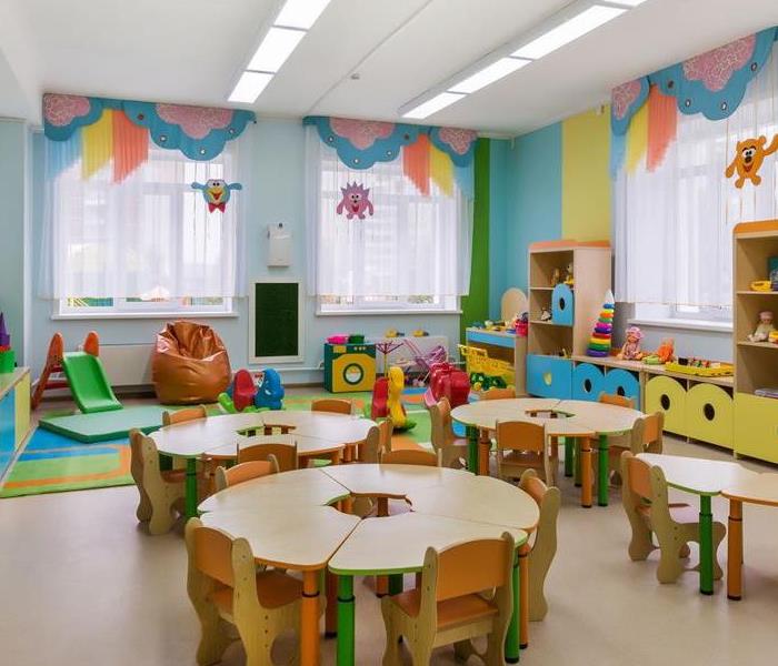 Room with children's table and chairs, and decorations for children on the walls