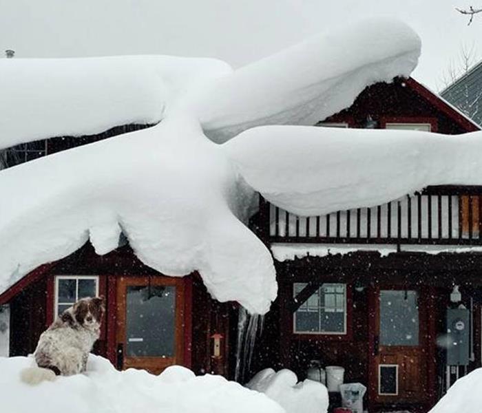 Home covered in snow with snow dams 