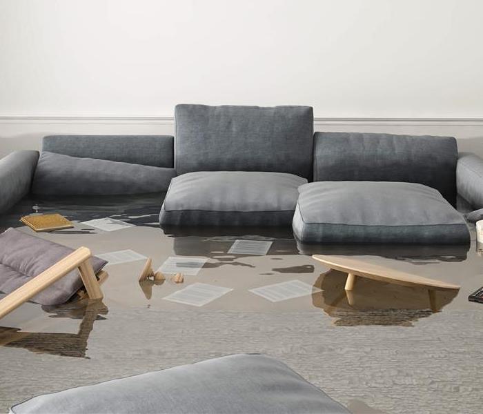A basement is flooded with 5-6" water, with furniture floating